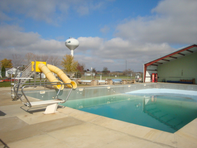 The Meinerz Dairyland Pool in Fredericksburg. There is a yellow water slide on the left.